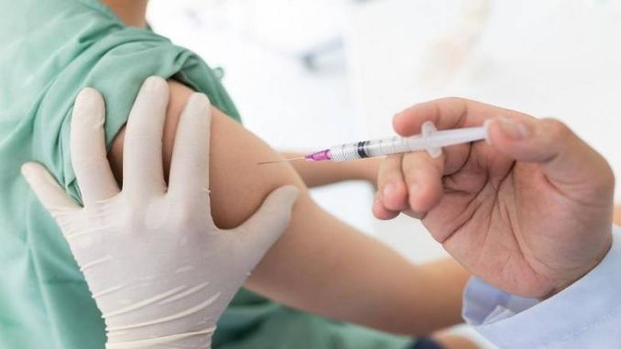 Injection d'une dose de vaccin à un patient.
