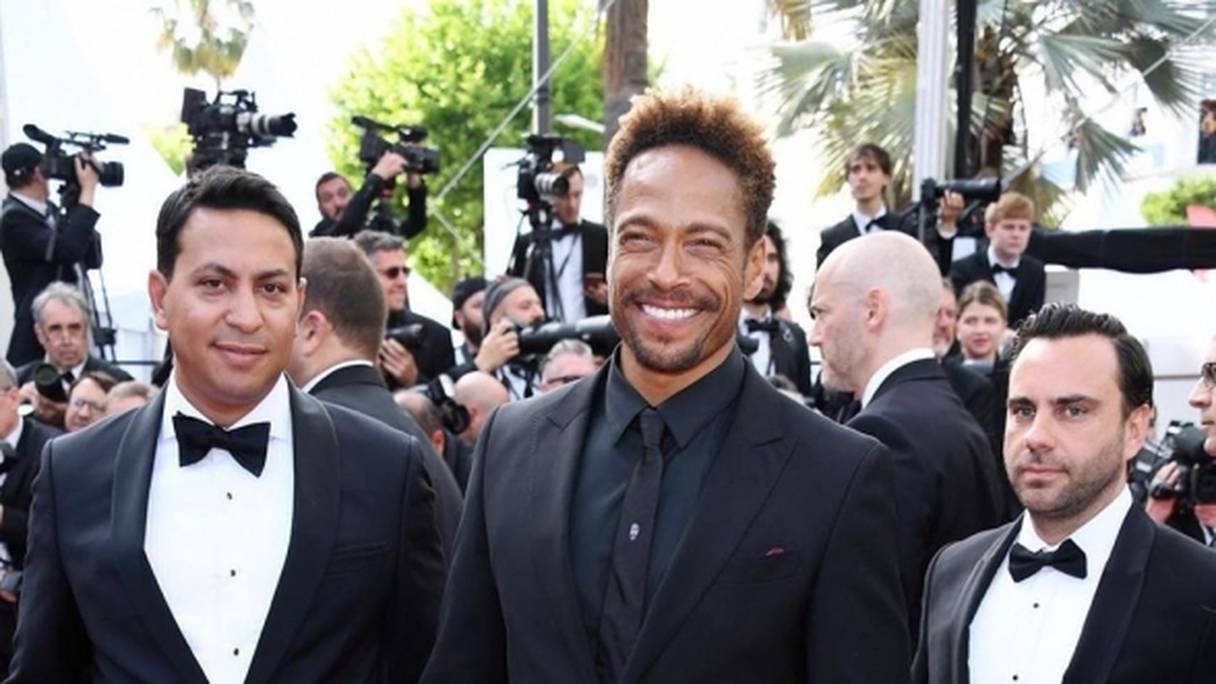 Le producteur et réalisateur marocain (à gauche) présente son premier film, "Redemption Day", à Cannes. A sa droite, l'acteur Gary Dourdan, qui a joué dans son film.
