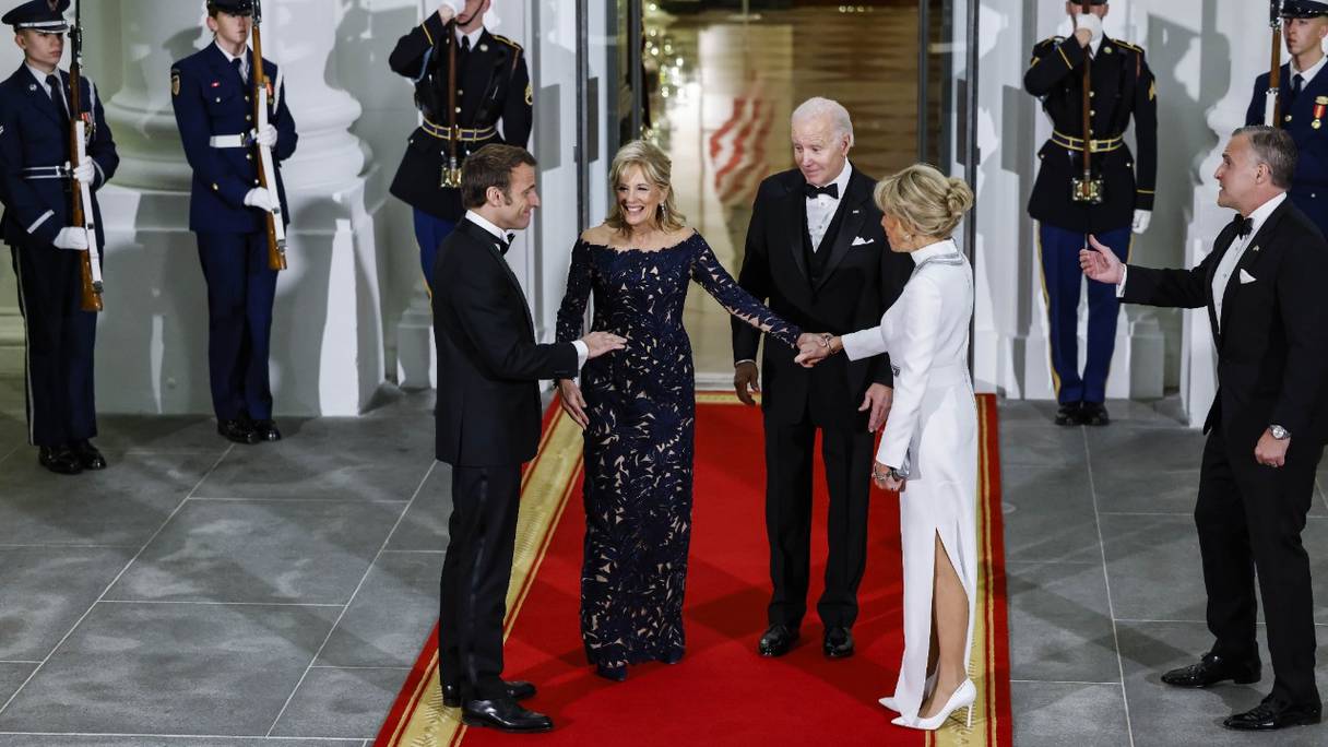 Le président américain Joe Biden et la première dame Jill Biden saluent le président français Emmanuel Macron et son épouse, Brigitte Macron, à leur arrivée à un dîner d'Etat à la Maison Blanche à Washington, le 1er décembre 2022.
