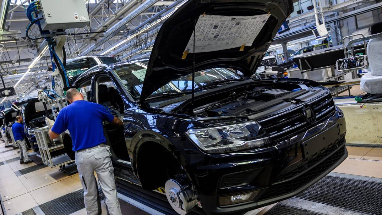 Un ouvrier installe des sièges dans une Seat Tarraco dans une chaîne de production de l'usine du géant allemand de la fabrication automobile Volkswagen à Wolfsburg, dans le nord de l'Allemagne, le 1er mars 2019.
