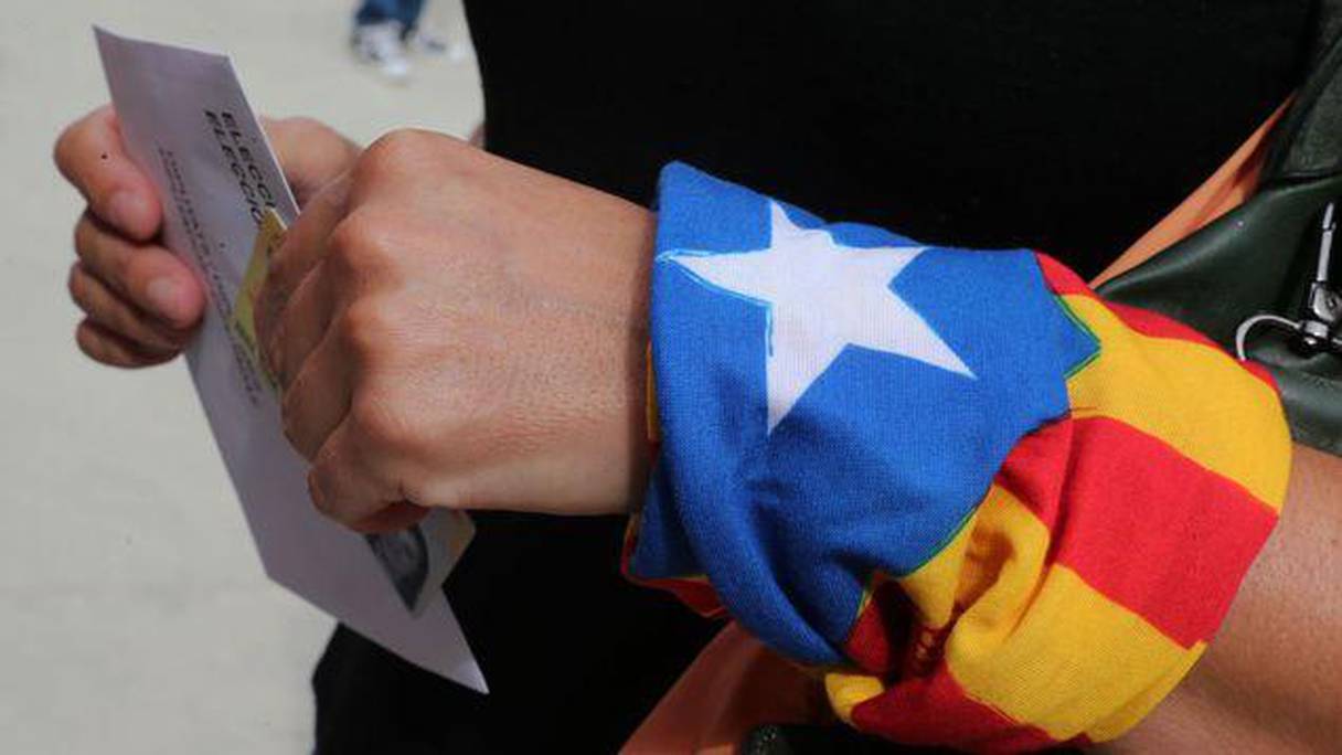 Une femme, un foulard indépendantiste au poignet, dans un bureau de vote ce 27 septembre 2015.
