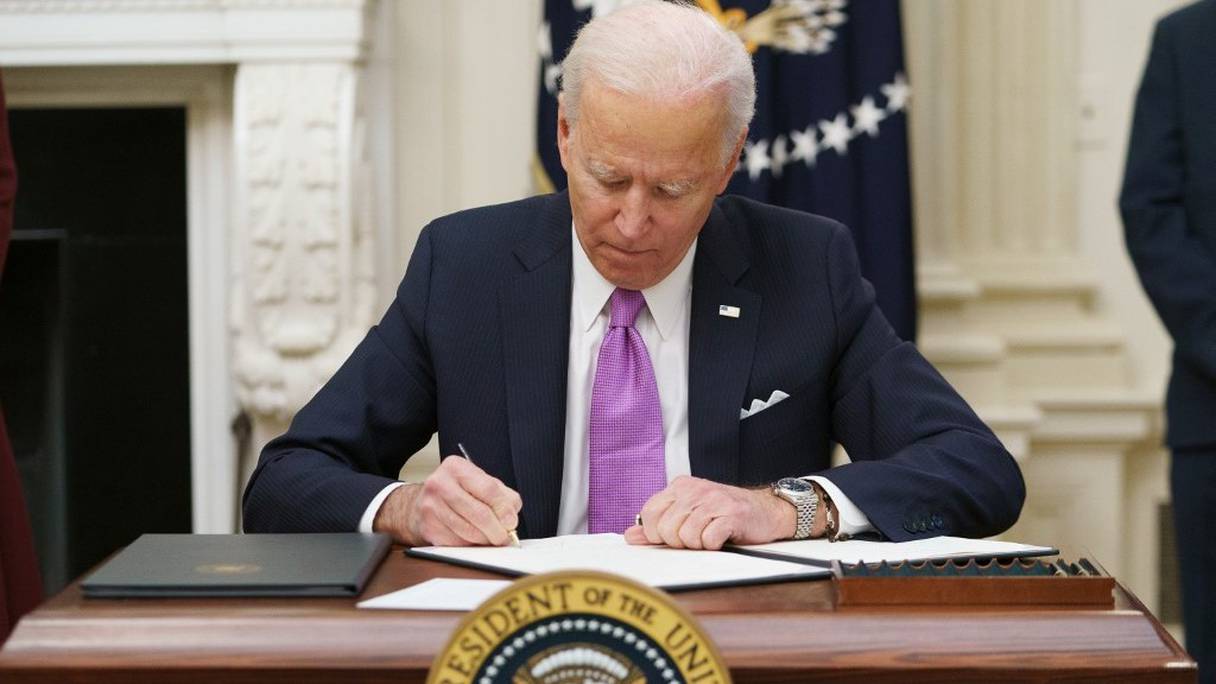 Le président américain Joe Biden signe des décrets dans le cadre de la réponse au Covid-19, dans la salle à manger d'Etat de la Maison Blanche à Washington, le 21 janvier 2021.
