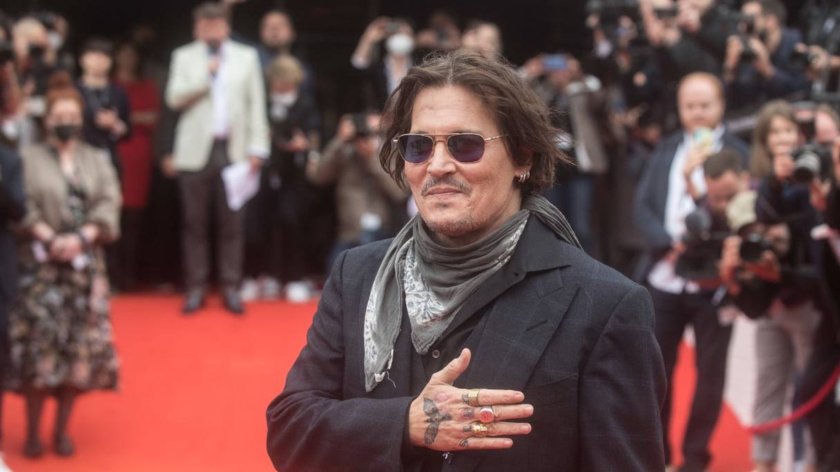 L'acteur et producteur américain Johnny Depp salue ses fans sur le tapis rouge avant la projection du film "Crock of Gold; à quelques tours avec Shane MacGowan" lors de la 55e édition du Festival international du film de Karlovy Vary (KVIFF), en Tchéquie, le 27 août 2021.
