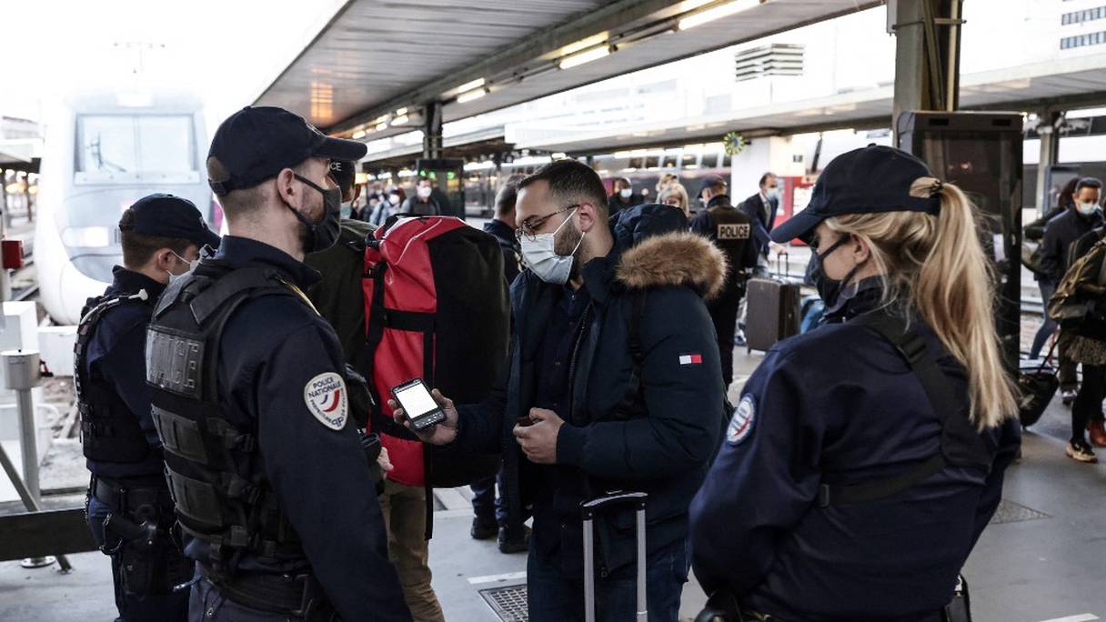 Contrôles de police sur les passagers débarquant d'un train arrivant de Mulhouse pour inspecter leurs notes de justification de voyage, le 26 mars 2021, à la gare de Lyon, à Paris. 
