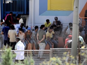 Des migrants se rassemblent dans une installation de traitement opérationnel de migrants dans l'île de Lampedusa, dans le sud de l'Italie, le 4 août 2022.