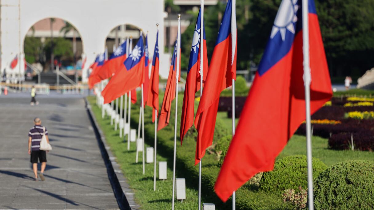 Un homme passe devant des drapeaux taïwanais hissés sur le boulevard de la démocratie, au mémorial de Tchang Kaï-chek à Taipei, le 15 octobre 2024
