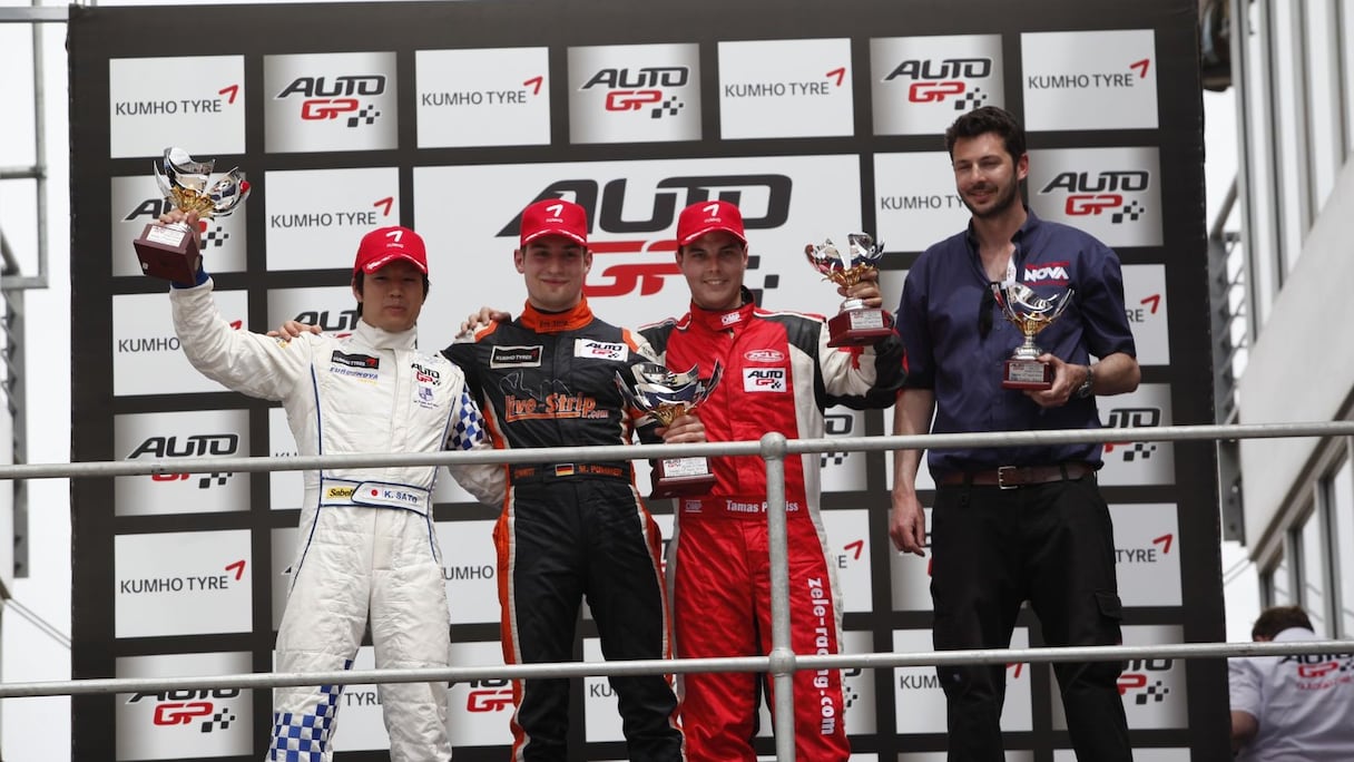 Le podium de cette course 2 d'auto GP est formé par le vainqueur Markus Pommer (au centre), Kimiya Sato, deuxième après sa victoire en course 1 (à gauche) et Tamas Pal Kiss, troisième (à droite).
