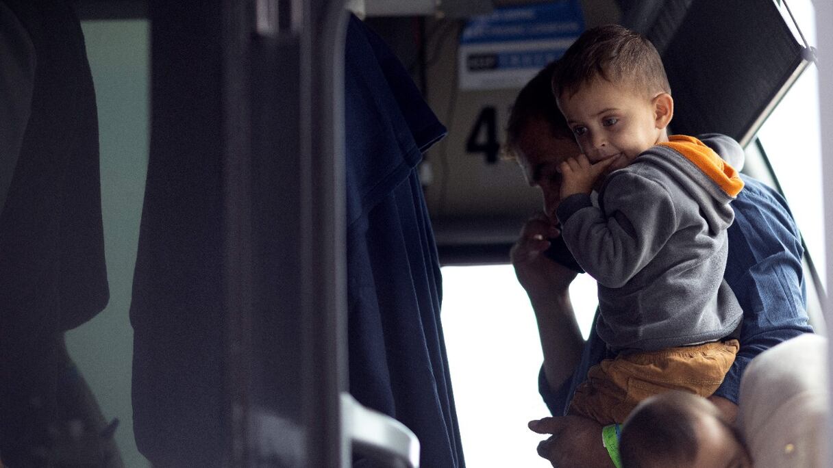 Des réfugiés évacués de Kaboul en Afghanistan montent à bord d'un bus à l'aéroport international de Dulles qui les conduira à un centre de traitement des réfugiés, le 26 août 2021 à Dulles, en Virginie.
