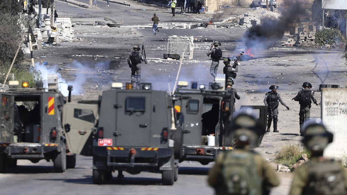 Les forces d'occupation israéliennes tirent des gaz lacrymogènes lors d'affrontements avec des manifestants palestiniens à la suite d'une manifestation en soutien à la mosquée al-Aqsa, le 15 avril 2022.
