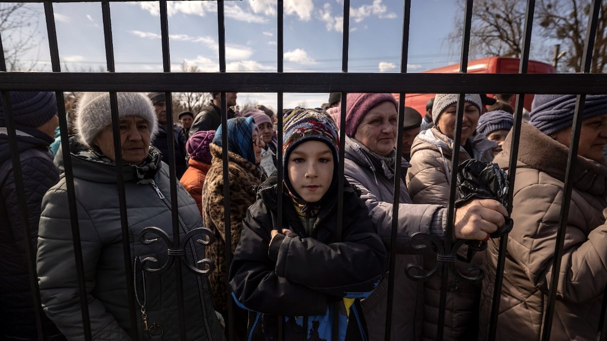 Des habitants attendent de la nourriture devant une église dans la ville de Trostianets, dans le nord-est du pays, le 29 mars 2022.
