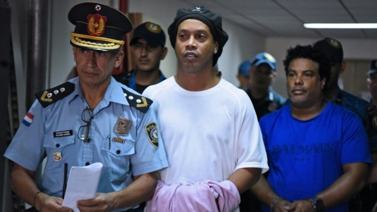L'ancienne star du football, le Brésilien Ronaldinho (C), arrive au Palais de justice d'Asuncion le 7 mars 2020 à Asuncion
