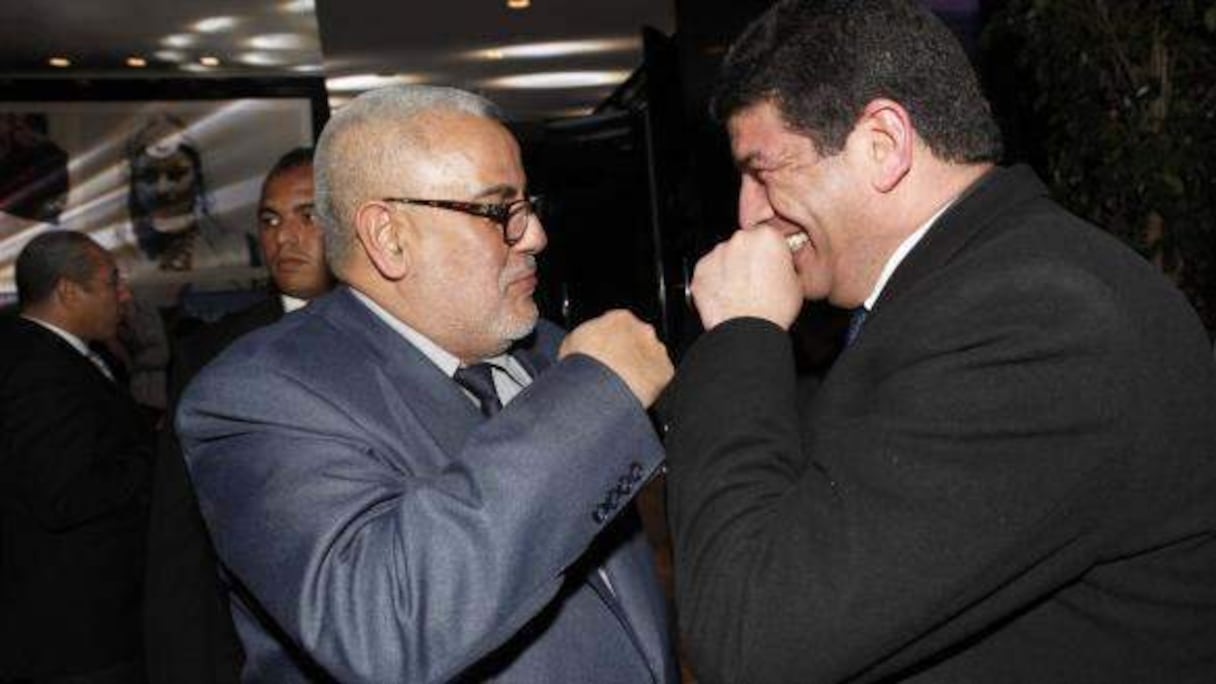 Abdelilah Benkirane et Mustapha Bakkoury, S.G du PAM, lors d'une soirée mondaine début 2014.
