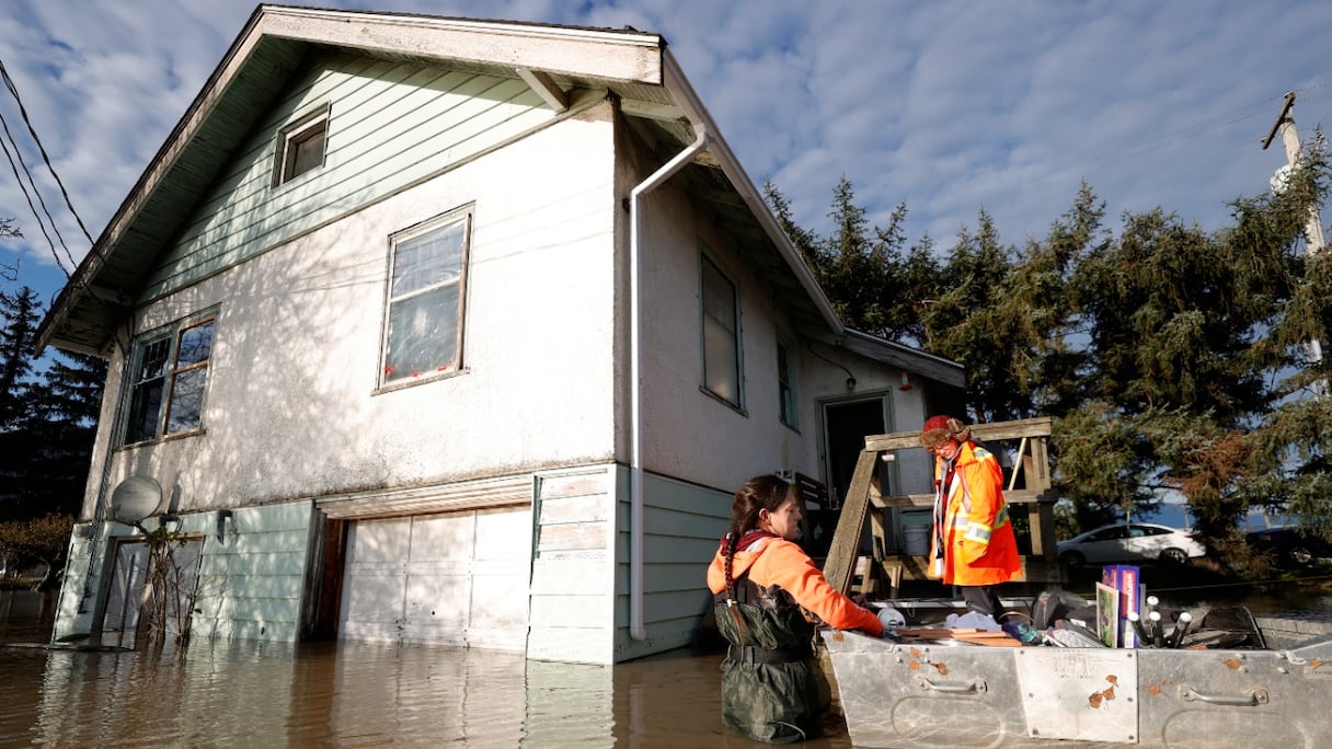 Des objets personnels sont mis à l'abri dans un bateau près d'une maison à moitié sous les flots, le 21 novembre 2021, au cours d'une précédente inondation à Abbotsford (Colombie-Britannique), au Canada -photo d'archives.
