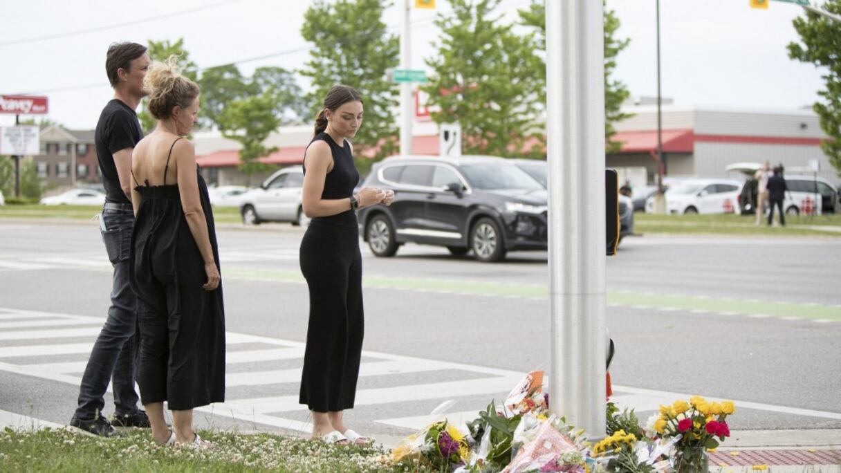 Des personnes rendent hommage aux quatre membres d'une famille musulmane tués par un homme conduisant un pick-up, dans les lieux où s'est déroulée cette attaque, à London, en Ontario, le 7 juin 2021. 
